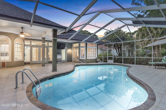 pool featuring ceiling fan, a patio area, and glass enclosure