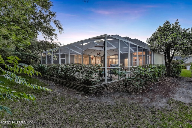 back of property at dusk with glass enclosure