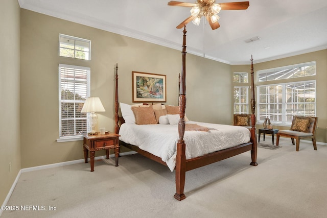 carpeted bedroom featuring crown molding, baseboards, visible vents, and ceiling fan