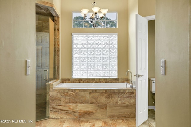 full bath featuring a bath, an inviting chandelier, marble finish floor, and a stall shower