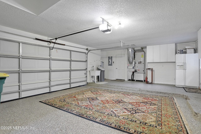 garage with heating unit, white fridge with ice dispenser, and a garage door opener