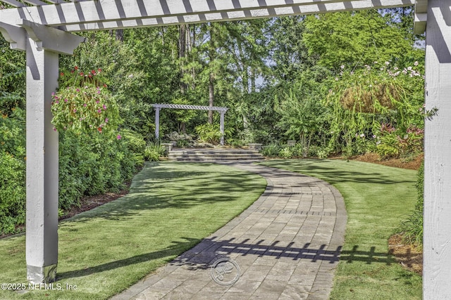 view of home's community with a yard and a pergola