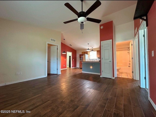 170 Spruce Rd, Ocala, FL 34472 - unfurnished living room with dark wood-type flooring, a ceiling fan, vaulted ceiling, and baseboards