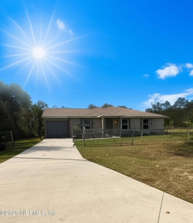 170 Spruce Rd, Ocala, FL 34472 - ranch-style house with concrete driveway, fence private yard, a garage, and a front lawn