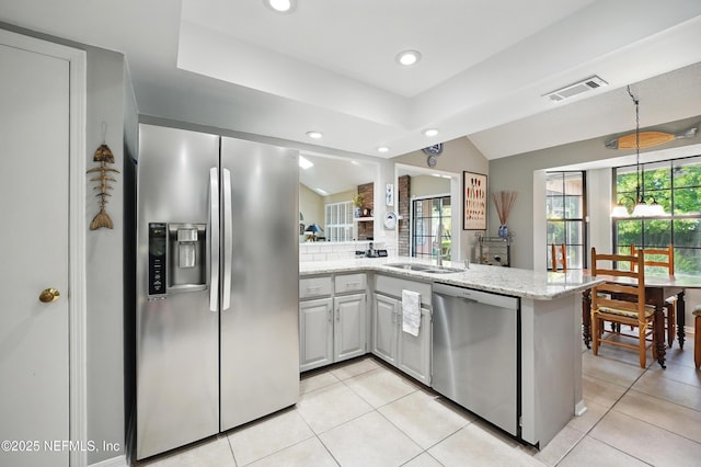 kitchen with recessed lighting, a sink, stainless steel appliances, visible vents, and light stone counters