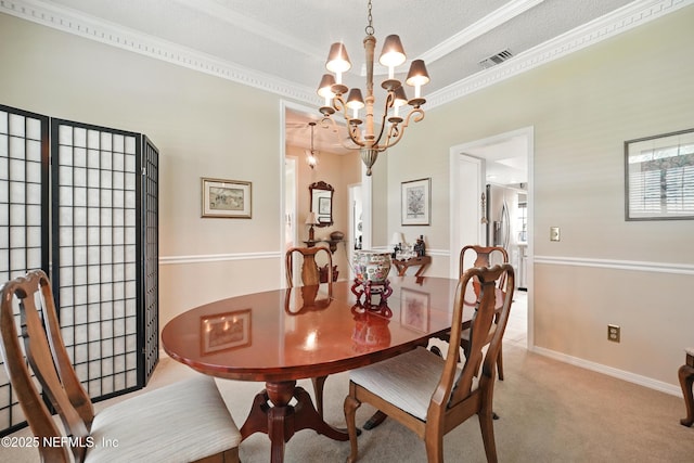 dining room with an inviting chandelier, crown molding, visible vents, light carpet, and a textured ceiling
