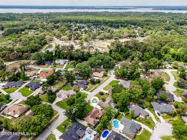 bird's eye view featuring a residential view, a water view, and a view of trees
