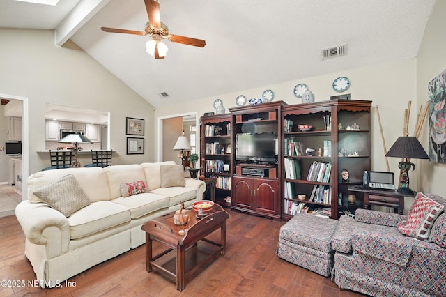 living room with a ceiling fan, visible vents, and wood finished floors