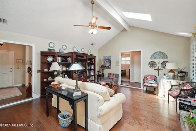 living room with lofted ceiling with skylight, ceiling fan, hardwood / wood-style floors, and baseboards