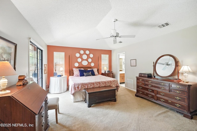 bedroom featuring light colored carpet, visible vents, vaulted ceiling, and a textured ceiling