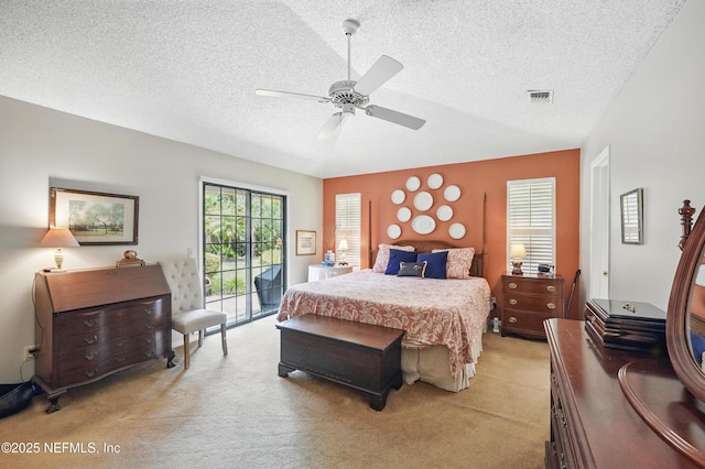 bedroom with access to outside, light carpet, and a textured ceiling