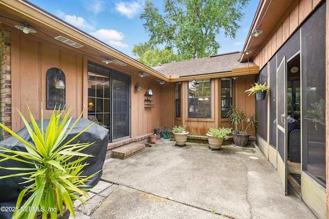 entrance to property with a patio area and board and batten siding