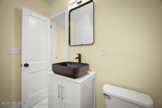 6422 Kathryn Dr, Jacksonville, FL 32208 - half bath featuring a sink, marble finish flooring, and toilet
