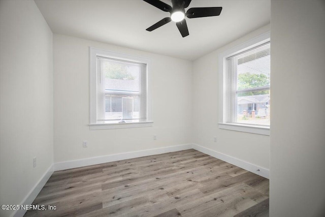 6422 Kathryn Dr, Jacksonville, FL 32208 - empty room featuring healthy amount of natural light, ceiling fan, wood finished floors, and baseboards