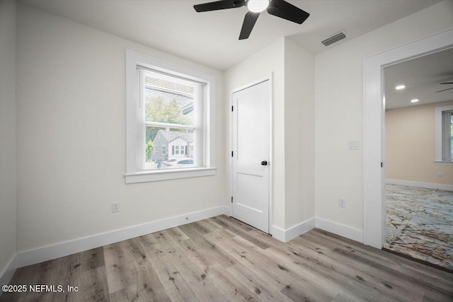 6422 Kathryn Dr, Jacksonville, FL 32208 - unfurnished bedroom featuring multiple windows, light wood finished floors, baseboards, and recessed lighting