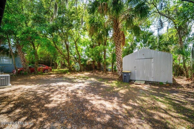 6422 Kathryn Dr, Jacksonville, FL 32208 - view of yard with a storage unit, central AC, and an outbuilding