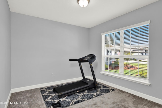 workout room with carpet floors and baseboards