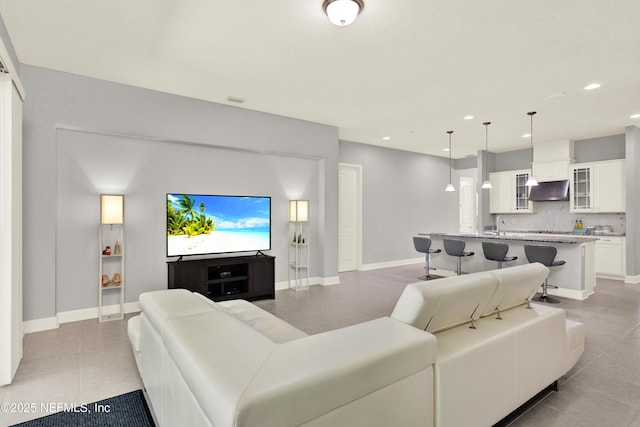 living room with recessed lighting, baseboards, and light tile patterned floors