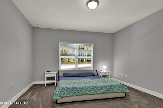 carpeted bedroom with baseboards and a textured ceiling