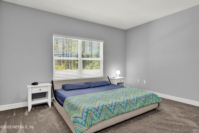 carpeted bedroom featuring baseboards