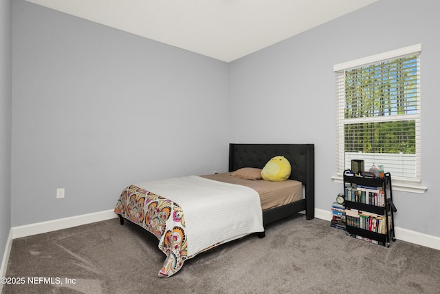 bedroom with carpet floors and baseboards