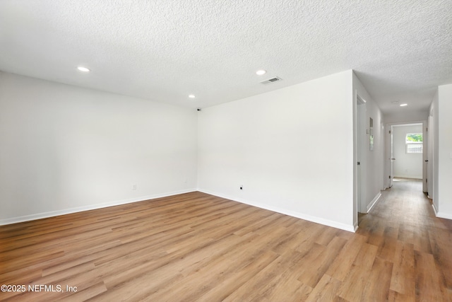 spare room with visible vents, recessed lighting, and light wood-style floors