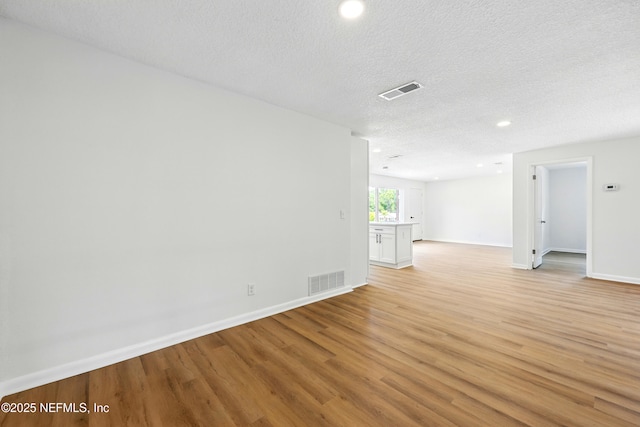 spare room featuring recessed lighting, baseboards, visible vents, and light wood-type flooring