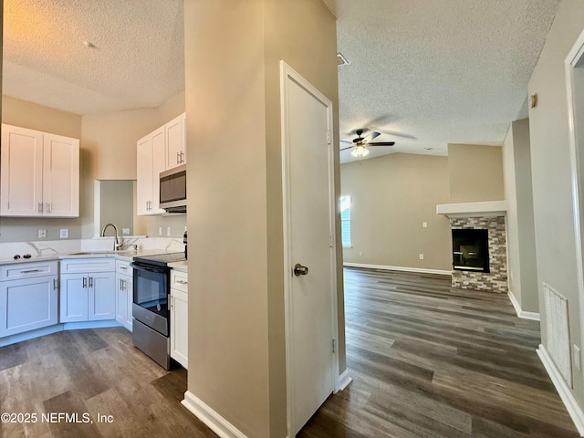 12359 Silent Brook Trl N, Jacksonville, FL 32225 - kitchen featuring a textured ceiling, stainless steel microwave, a ceiling fan, and range with electric stovetop
