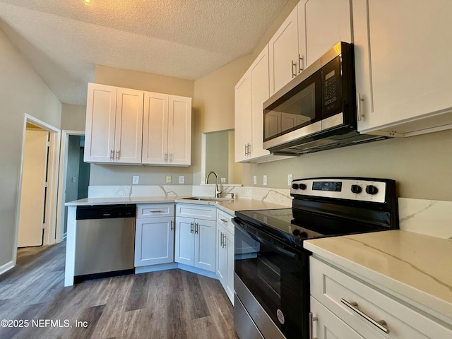 12359 Silent Brook Trl N, Jacksonville, FL 32225 - kitchen with dark wood finished floors, appliances with stainless steel finishes, white cabinetry, and a sink
