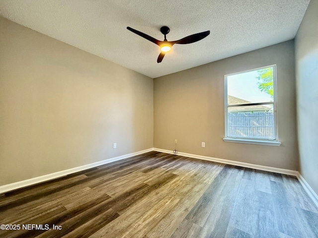 12359 Silent Brook Trl N, Jacksonville, FL 32225 - empty room with dark wood-type flooring, ceiling fan, baseboards, and a textured ceiling
