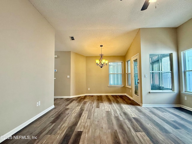 12359 Silent Brook Trl N, Jacksonville, FL 32225 - unfurnished dining area with baseboards, ceiling fan with notable chandelier, a textured ceiling, and dark wood-style flooring