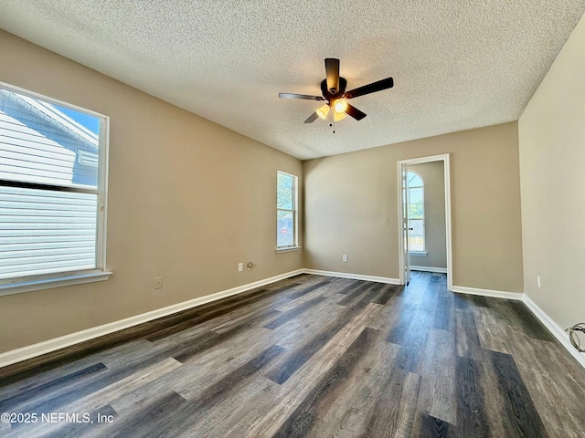 12359 Silent Brook Trl N, Jacksonville, FL 32225 - spare room featuring a textured ceiling, a ceiling fan, dark wood finished floors, and baseboards