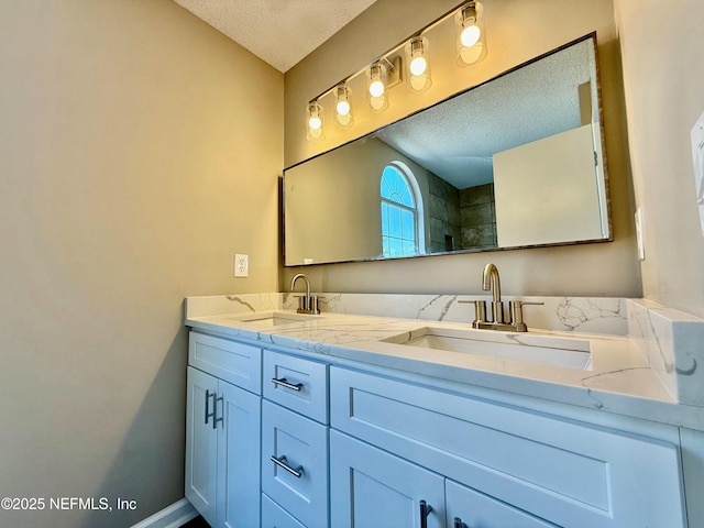 12359 Silent Brook Trl N, Jacksonville, FL 32225 - full bathroom featuring double vanity, a textured ceiling, baseboards, and a sink