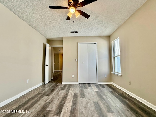 12359 Silent Brook Trl N, Jacksonville, FL 32225 - unfurnished bedroom featuring dark wood-style flooring, ceiling fan, visible vents, baseboards, and a textured ceiling