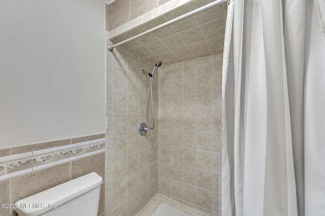 bathroom with toilet and tiled shower