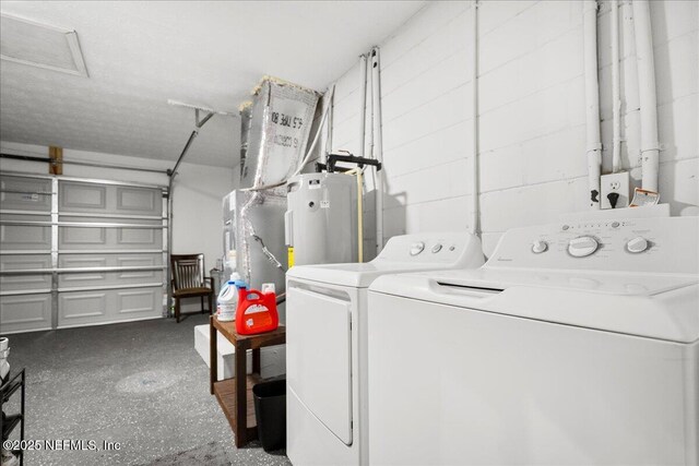 clothes washing area featuring washing machine and clothes dryer and laundry area