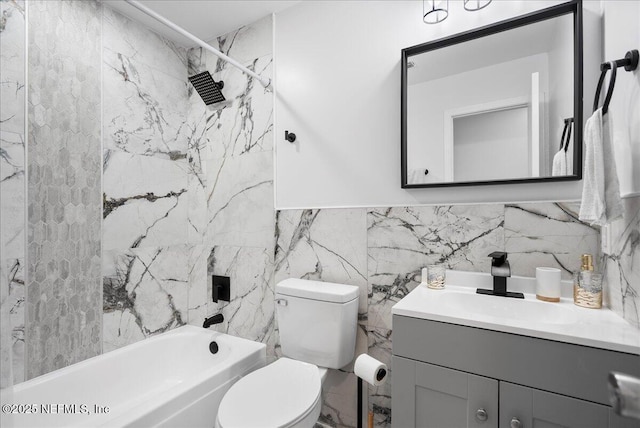 bathroom with vanity, toilet, shower / bath combination, and tile walls