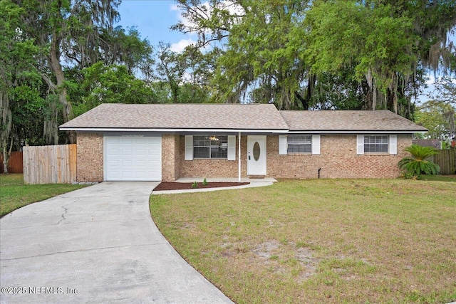 ranch-style house featuring concrete driveway, a front lawn, and fence