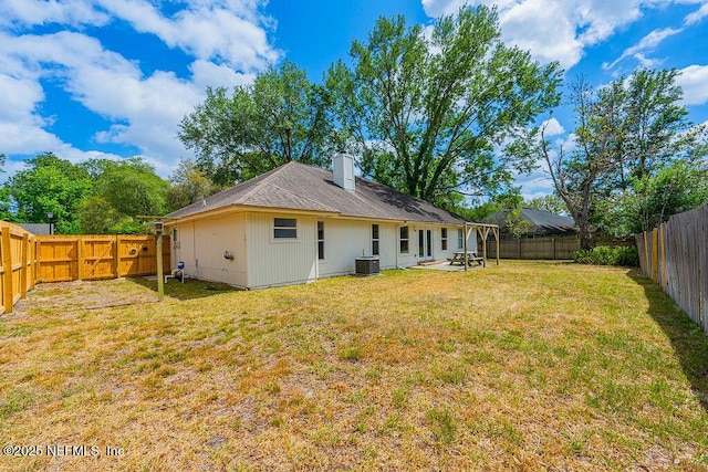 1218 Shallowford Dr E, Jacksonville, FL 32225 - back of house featuring central AC, a chimney, and a patio