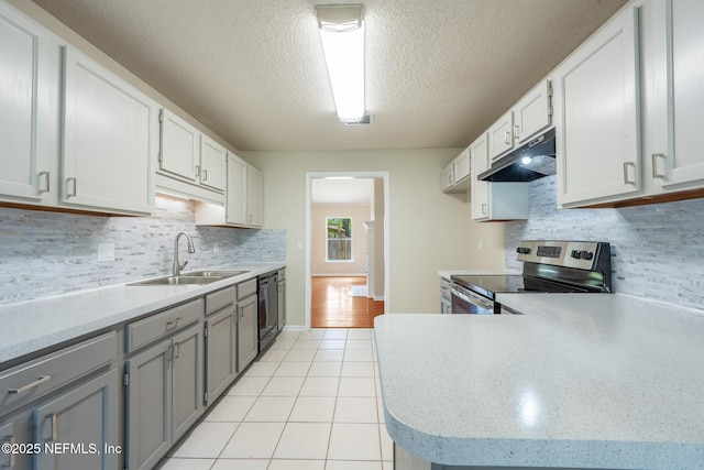 1218 Shallowford Dr E, Jacksonville, FL 32225 - kitchen featuring stainless steel electric stove, a sink, under cabinet range hood, gray cabinets, and light tile patterned floors