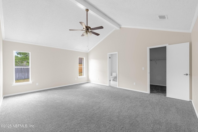 1218 Shallowford Dr E, Jacksonville, FL 32225 - unfurnished bedroom with beam ceiling, carpet floors, baseboards, a walk in closet, and connected bathroom
