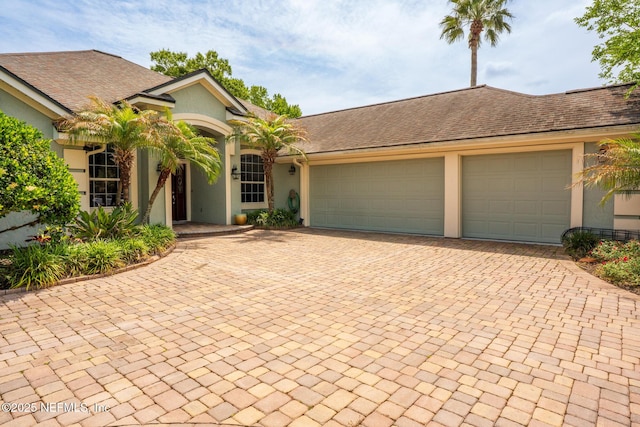 3771 Saltmeadow Ct S, Jacksonville, FL 32224 - view of front facade with a garage, stucco siding, and decorative driveway