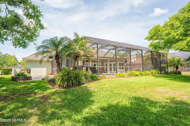 3771 Saltmeadow Ct S, Jacksonville, FL 32224 - back of property with stucco siding, a yard, and a lanai