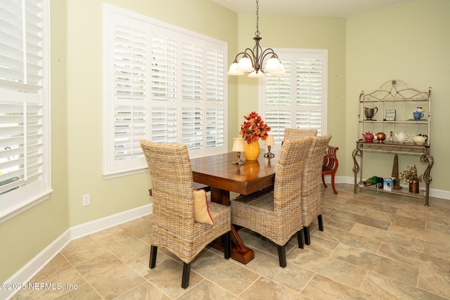 3771 Saltmeadow Ct S, Jacksonville, FL 32224 - dining room with a chandelier, healthy amount of natural light, baseboards, and light stone finish flooring