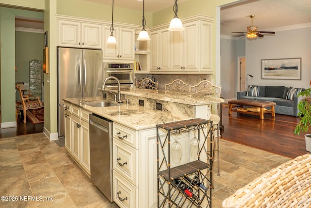 3771 Saltmeadow Ct S, Jacksonville, FL 32224 - kitchen with appliances with stainless steel finishes, a sink, cream cabinetry, ceiling fan, and backsplash
