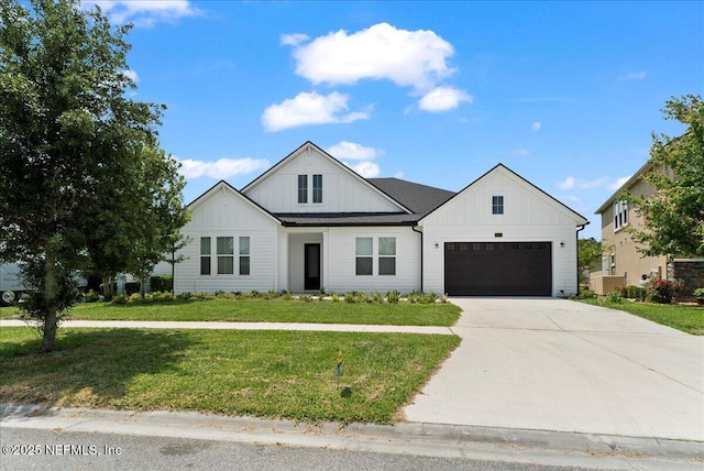 982 Oakland Hills Ave, Middleburg, FL 32068 - modern farmhouse style home featuring an attached garage, board and batten siding, a front yard, and concrete driveway