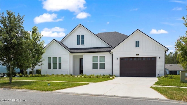 982 Oakland Hills Ave, Middleburg, FL 32068 - modern farmhouse style home featuring a garage, a front lawn, board and batten siding, and driveway