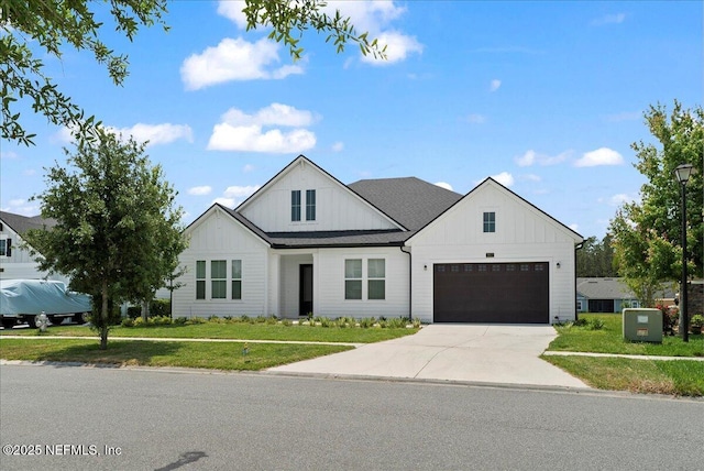 982 Oakland Hills Ave, Middleburg, FL 32068 - modern farmhouse style home featuring board and batten siding, an attached garage, driveway, and a front lawn