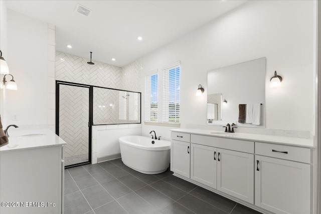 982 Oakland Hills Ave, Middleburg, FL 32068 - full bathroom featuring a sink, a freestanding bath, a stall shower, and two vanities