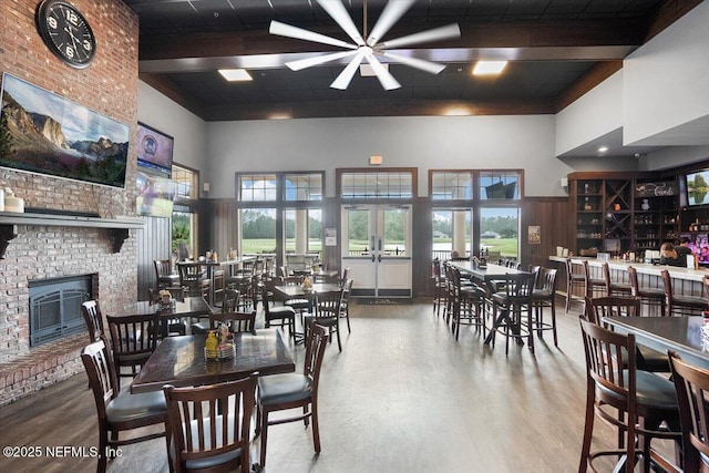 982 Oakland Hills Ave, Middleburg, FL 32068 - dining room with ceiling fan, a fireplace, wood finished floors, and a towering ceiling